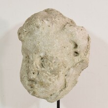 Weathered stucco/stone paste fragment of an angel head, France circa 1650-1750