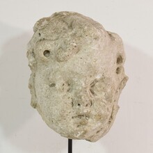 Weathered stucco/stone paste fragment of an angel head, France circa 1650-1750