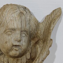 Baroque carved oak angel head on wing, France circa 1750