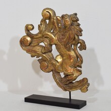 Hand carved giltwood standing lion on curl, France circa 1750