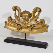 Carved giltwood ornament with winged angel head, France circa 1900
