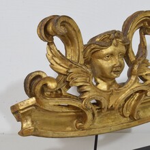 Carved giltwood ornament with winged angel head, France circa 1900