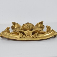 Carved giltwood ornament with winged angel head, France circa 1900
