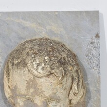 Carved stone cherub fountain head on marble panel, Italy circa 1650-1750