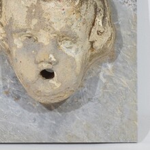 Carved stone cherub fountain head on marble panel, Italy circa 1650-1750