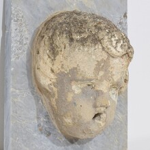 Carved stone cherub fountain head on marble panel, Italy circa 1650-1750