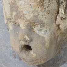 Carved stone cherub fountain head on marble panel, Italy circa 1650-1750