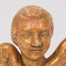 Small baroque carved giltwood angel head on wings, France circa 1750