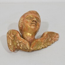 Small baroque carved giltwood angel head on wings, France circa 1750