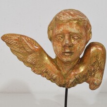 Small baroque carved giltwood angelhead on wings, France circa 1750