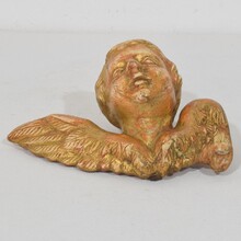 Small baroque carved giltwood angelhead on wings, France circa 1750